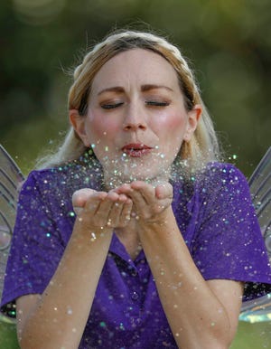 In this May 8, 2019 photo, Amy Sharpe poses with her angel wings in Lakeland, Fla. Sharpe started a business called Dreams Come True Entertainment in 2011. She provides princesses and superheroes for birthday parties and other kids' events. She also does charity events. (Pierre DuCharme/The Ledger via AP)