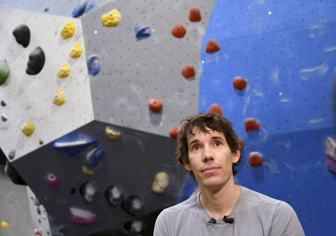 In this June 18, 2019, photo, professional rock climber Alex Honnold is interviewed at the Earth Treks gym in Englewood, Colo. Honnold is trying to get a grip on life in the aftermath of the Academy Award winning documentary "Free Solo." His fear is that maybe his 2017 ropeless climb of El Capitan in Yosemite featured in the spine-tingling film just might be the summit of his career. (AP Photo/Thomas Peipert)