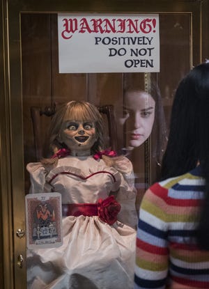 Daniela (Katie Sarife) with Annabelle in "Annabelle Comes Home" [WARNER BROS.]