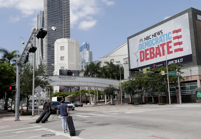 A billboard advertises the Democratic Presidential Debates across from the Knight Concert Hall at the Adrienne Arsht Center for the Performing Arts of Miami-Dade County, Monday, June 24, 2019, in Miami. The debates are scheduled to take place June 26 and 27, with 10 candidates competing each night. [AP Photo/Lynne Sladky]