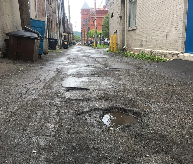 Some sections of Burmese Lane, an alley off Market Street, are known for some deep potholes. [SHAWN VARGO/THE LEADER]