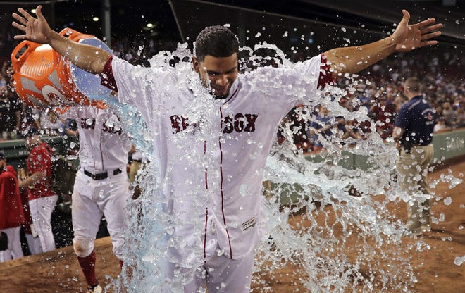 Red Sox infielder Marco Hernandez is doused in water after his walk-off infield single gave Boston a 6-5 victory over the White Sox on Monday. [AP Photo/Charles Krupa]