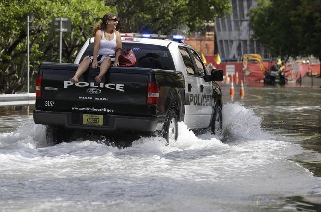 MIAMI BEACH -- Street flooding is often caused by high tides due to the lunar cycle, according to the National Weather Service. When Democratic presidential candidates meet in Miami for their first debate it'll be in what you could call the country's Ground Zero for any climate-related sea level rise. [AP Photo/Lynne Sladky]