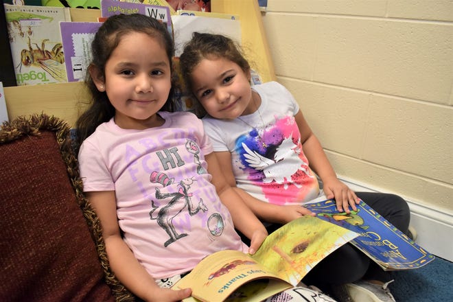 Two Head Start students enjoy newly donated books. [SUBMITTED PHOTO]