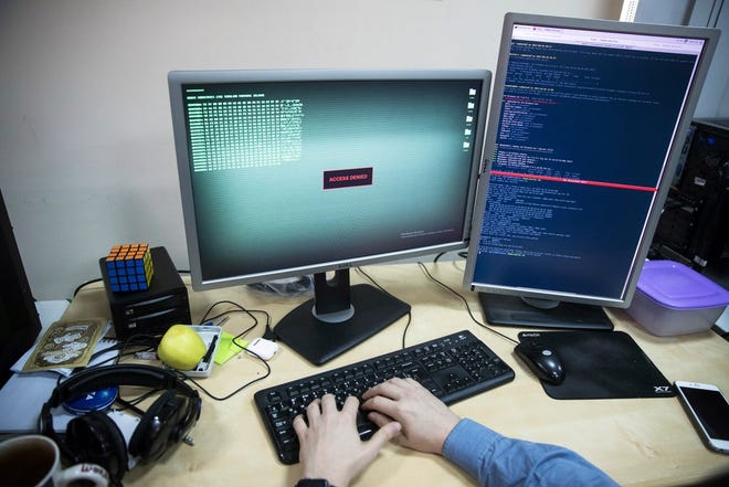An employee of Global Cyber Security Company Group-IB develops a computer code in an office in Moscow, Russia, Wednesday, Oct. 25, 2017. A new strain of malicious software has paralysed computers at a Ukrainian airport, the Ukrainian capital's subway and at some independent Russian media. Moscow-based Global Cyber Security Company Group-IB said in a statement Wednesday the ransomware called BadRabbit also tried to penetrate the computers of major Russian banks but failed. None of the banks has reported any attacks. [AP Photo/Pavel Golovkin]
