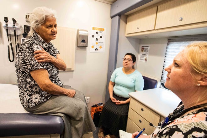 Katherine Schenck (far right) listens to Lidia Martinez, 74 during a visit to a CommUnity Care Health Centers' mobile clinic. Martinez's daughter-in-law Leticia Caldera accompanied her to the clinic that opened this week in Austin on Tuesday, June 25, 2019. [LOLA GOMEZ / AMERICAN-STATESMAN]