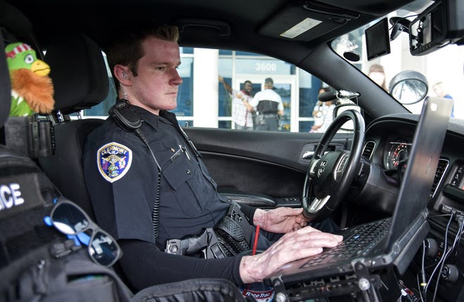 Officer Kris Kruse sits in his patrol car in Clermont. [PAUL RYAN / DAILY COMMERCIAL FILE]