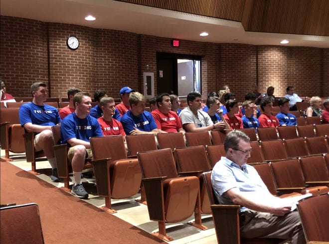 Several members of Revere High School's football team attend a school board meeting Tuesday. The board approved contracts for a new football coaching staff after officials said the previous coaches drank alcohol at a football camp. (Emily Mills / GateHouse Media Ohio)