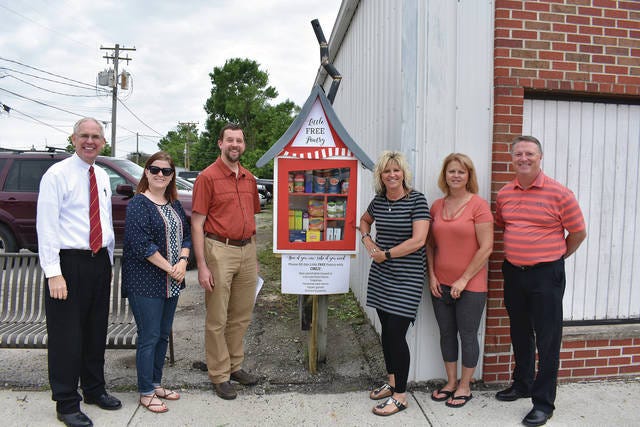 Rick Schreier, Ashlee Mullenbach, Pastor Kurt Jensen, Shelli Hassebrock, Deb Lage and John Sheahan were present for the dedication June 19 of the Little Free Pantry in Story City. Photo by Ronna Lawless