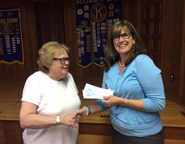 Alliance Kiwanis Club's support of Alliance YWCA programs continued with two check presentations. Kiwanis President Julie Lee, right, presents checks to Jan Ossler, YWCA program director, for the ABC For Kids Program and its upcoming golf event. The $150 donation for ABC will help buy school supplies for children involved in the Summer Explorers program at Alliance Middle School, and with a $70 gift Kiwanis will be a hole sponsor for the YWCA's 24th Annual Carnation Gold Scramble planned Aug. 2 at Tannenhauf Golf Club.
