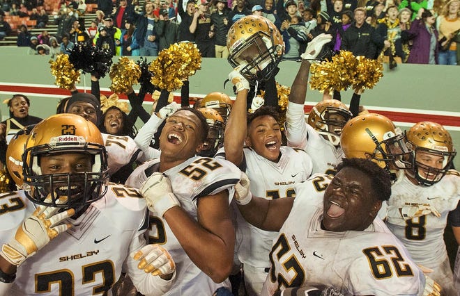 Shelby players celebrate their Class 2AA triumph over North Davidson at Raleigh's Carter-Finley Stadium last December. [Donnie Roberts/The Dispatch]
