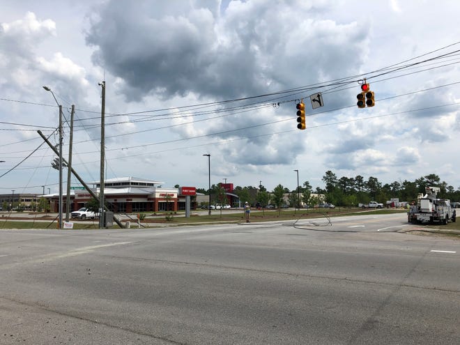 An incident involving a Morton Trucking dump truck caused a power outage in the Western Boulevard and Henderson Drive area in Jacksonville on Thursday. [Maxim Tamarov / The Daily News]