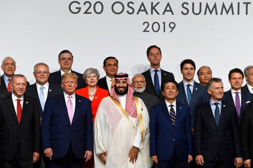 President Donald Trump, fifth from left, joins other leaders for a group photo at the G-20 summit in Osaka, Japan, Friday, June 28, 2019. (AP Photo/Susan Walsh)