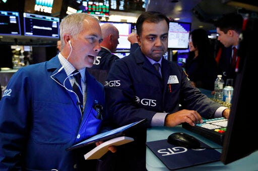 FILE - In this June 11, 2019, file photo trader Timothy Nick, left, and specialist Dilip Patel work on the floor of the New York Stock Exchange. The U.S. stock market opens at 9:30 a.m. EDT on Thursday, June 27. (AP Photo/Richard Drew, File)