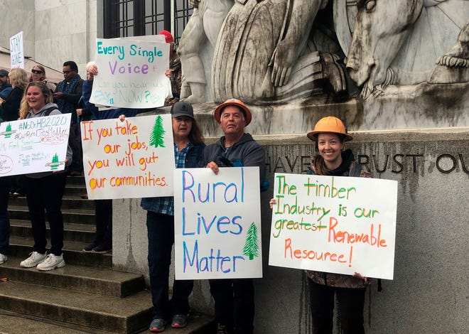Protesters converge outside the Oregon state Capitol in Salem, Ore. on Thursday, June 27, 2019. Truckers, loggers and farmers say they support the eleven Republican senators who walked out over a week ago to avoid a vote on climate legislation. (AP Photo/Sarah Zimmerman)