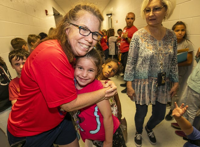 At Hammett Bowen Elementary School, kindergarten teacher Anne Marie Engelgau hugged Felicity Walters, 6, on the last day of class in May. Felicity will be going into the first grade for 2019-20. School grades should be coming out soon now that the Department of Education has released the results of state assessments. [Doug Engle/Ocala Star-Banner]