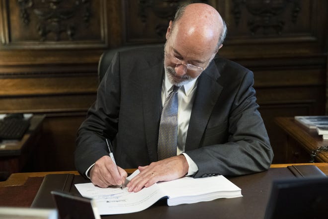 Pennsylvania Gov. Tom Wolf signs the main appropriations bill in a $34 billion budget package that passed the Legislature this week at the state Capitol in Harrisburg, Pa., Friday, June 28, 2019. [AP Photo/Matt Rourke]