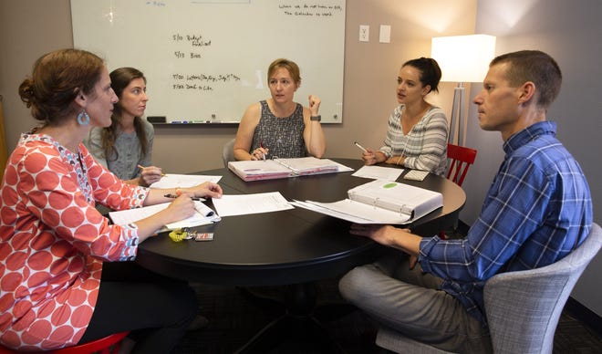From left: Therapist Carol Warren, Therapist Colleen Walsh, Senior Research Scientist Ashli Sheidow, Therpist Olivia Rogers and Senior Research Scientist Mike McCart discuss the clinical supervision of a case on which they are working at the Oregon Social Learning Center. [Andy Nelson/The Register-Guard] - registerguard.com