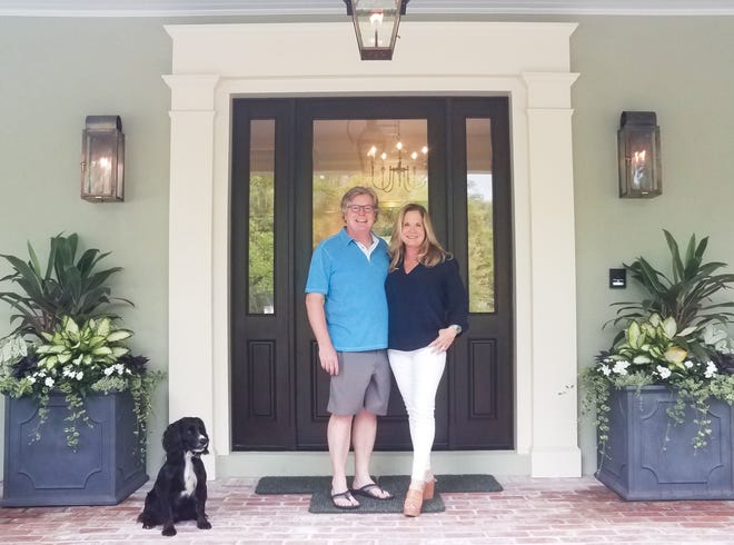 WELCOME HOME: Paula and Paul Loftus, and their field-bred English cocker spaniel Bracken, on the porch of their new right-sized home. Their advice to those attached to their big house: “Move on. We love our rightsized life. It’s liberating.” [Photo courtesy of Marni Jameson]
