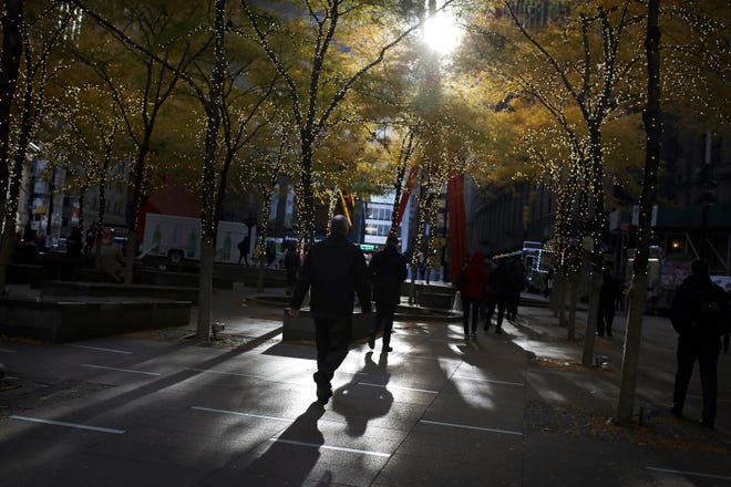 People walk through lower Manhattan's Zuccotti Park at the start of a workday in New York. A new study finds that only 4% of retirees start claiming their Social Security benefits at the most financially optimal time. [AP file photo]