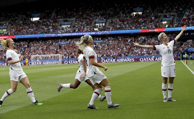 United States' Megan Rapinoe, right, celebrates after scoring her team's first goal during the Women's World Cup quarterfinal soccer match between France and the United States at Parc des Princes in Paris, France, Friday, June 28, 2019. (AP Photo/Alessandra Tarantino)