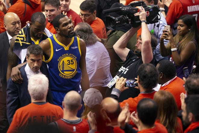 Warriors forward Kevin Durant leaves the floor after rupturing his Achilles during Game 5 of the NBA Finals earlier this month. [CHRIS YOUNG/The Canadian Press via AP]