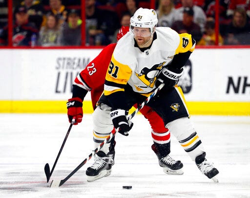 FILE - In this March 19, 2019, file photo, Pittsburgh Penguins' Phil Kessel (81) brings the puck upice after taking it away from Carolina Hurricanes' Brock McGinn (23) during the first period of an NHL hockey game in Raleigh, N.C. The Arizona Coyotes acquired high-scoring winger Kessel on Saturday, June 29, 2019, in a deal that sends center Alex Galchenyuk to the Penguins. (AP Photo/Karl B DeBlaker, File)