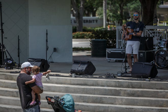 Matthew Peterson and his daughter Caroline danced to music in Abacoa's town center April 6 during Palm Beach County's first Seafood & Music Festival in Jupiter. The Jupiter Arts and Entertainment Preservation Coalition believes Jupiter officials can do more to encourage live music and performing arts in the town. [THOMAS CORDY/palmbeachpost.com]