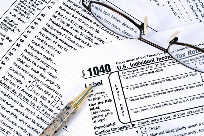 IRS Form 1040 can help you understand your tax burden when selling a home. [Dreamstime]