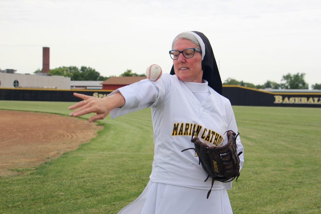 Sister Mary Jo Sobieck shows off her baseball skills at Marian Catholic High School in Chicago Heights, Ill., on June 21, 2019, where she teaches theology. Sobieck is nominated for an ESPY for "Best Viral Sports Moment" for the perfect curveball she threw last year as a ceremonial pitch before a Chicago White Sox game. RNS photo by Emily McFarlan Miller