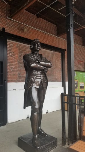 A statue of Samuel Adams stands outside the taproom at the Boston Brewery. [Taunton Gazette Photo | Kristina Fontes]