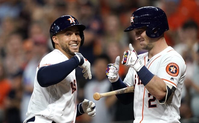 Houston Astros' George Springer, left, celebrates with Alex Bregman after hitting a home run against the Pittsburgh Pirates during the first inning of a baseball game Wednesday in Houston. [David J. Phillip/The Associated Press]