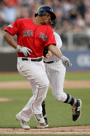 Boston Red Sox's Rafael Devers, left, is tagged out at first by New York Yankees second baseman DJ LeMahieu during the eighth inning of a baseball game in London, Sunday, June 30, 2019. (AP Photo/Tim Ireland)