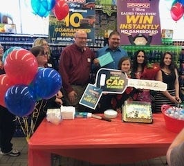 John Paul is pictured in the blue shirt in this photo with his family and Tops store manager, Bob Clinton. [PHOTO PROVIDED]