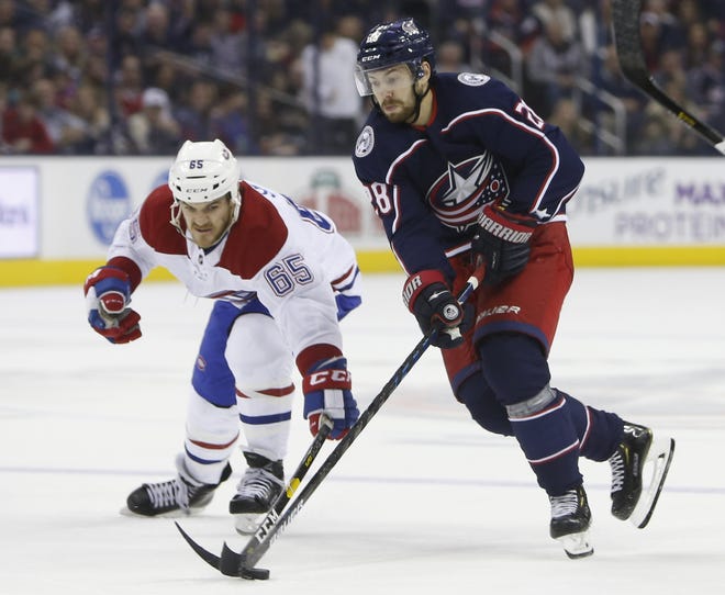 Montreal Canadiens' Andrew Shaw, left, and Columbus Blue Jackets' Oliver Bjorkstrand, of Denmark, chase a loose puck during the second period of an NHL hockey game Thursday, March 28, 2019, in Columbus, Ohio. (AP Photo/Jay LaPrete)