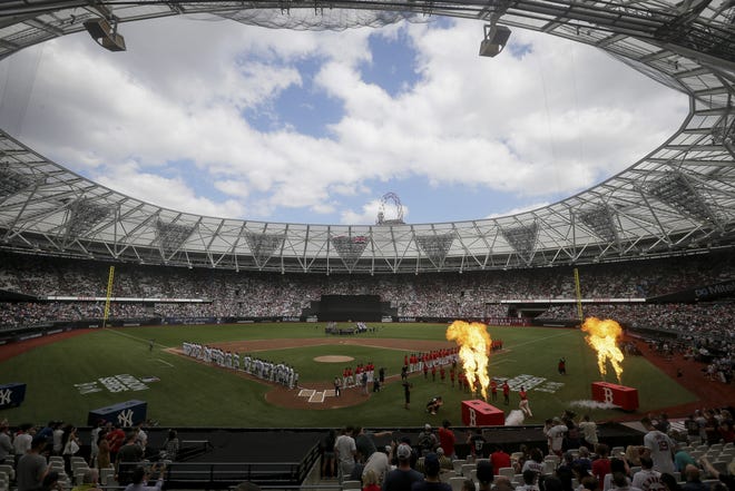 The New York Yankees and the Boston Red Sox line up for the national anthem before a baseball game in London on Sunday. [AP Photo/Tim Ireland]