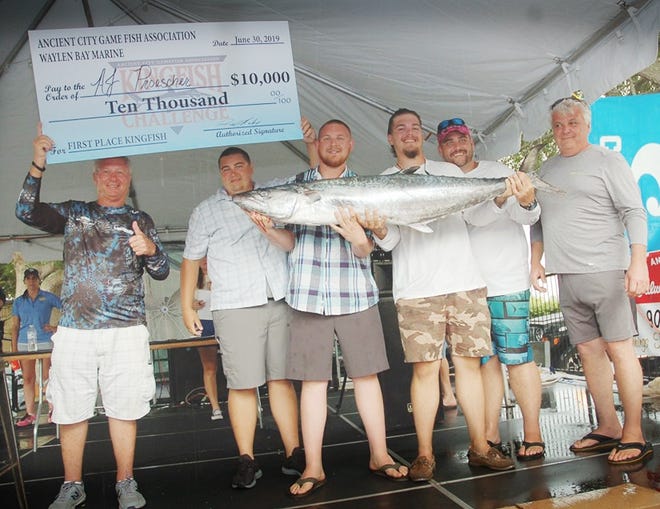 A.J. Proescher and his crew hold up their prize-winnning fish after winning the 2019 Ancient City Game Fish Association Kingfish Challenge on Sunday evening. Their two-fish aggregate of 99.28 pounds was nearly 15 pounds ahead of second place. [CONTRIBUTED]