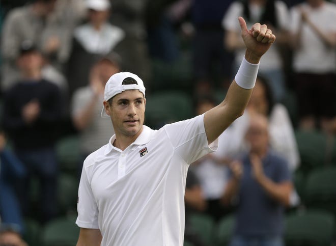 United States, and former Georgia Bulldog John Isner reacts after winning against Norway's Casper Ruud in a Men's singles match during day two of the Wimbledon Tennis Championships in London on Tuesday. (AP Photo/Tim Ireland)