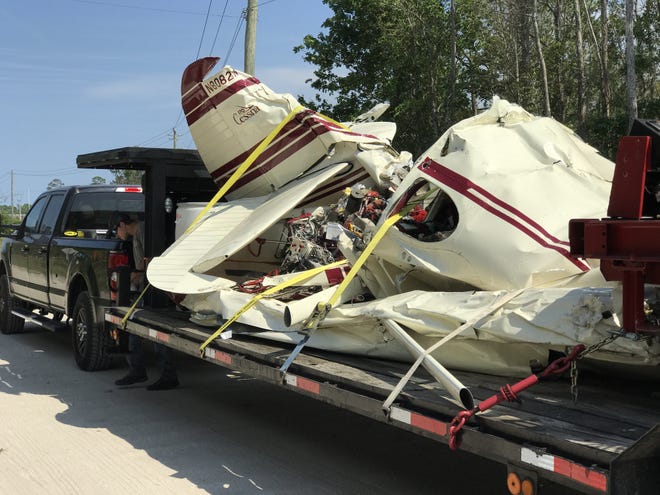 The wreckage of a Cessna 170 is removed from a crash scene near Interstate 95 in Edgewater on April 1, 2017. The mid-air collision of two planes in formation ended in the deaths of two highly experienced pilots and a recent report by the National Transportation Safety Board suggests the planes' dissimilarity may have been a factor in the crash. [News-Journal file/Patricio G. Balona]