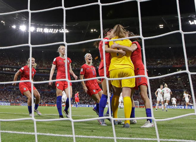 Teammates hug United States goalkeeper Alyssa Naeher after she saved a penalty kick by England's Steph Houghton during the Women's World Cup semifinal at the Stade de Lyon, outside Lyon, France, on Tuesday. The save helped preserve the Americans' 2-1 victory that put them through to Sunday's final. [AP Photo/Alessandra Tarantino]