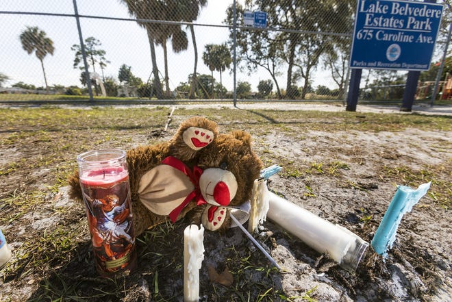 A memorial to two teenagers killed in a shooting sits in Lake Belvedere Estates Park Tuesday afternoon January 15, 2019. Moltere Charles Jr., 17, and 16-year-old Frederick Rosemond died in an early Sunday morning shooting at the park.  [LANNIS WATERS/palmbeachpost.com]