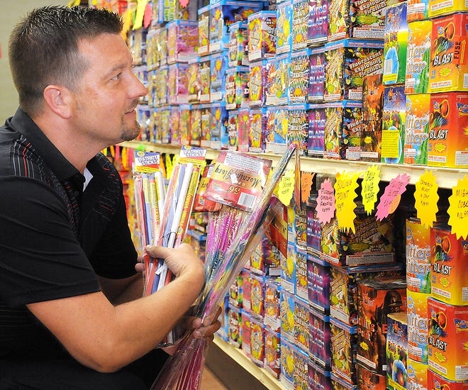 Customer Chad DeMattei checks out the vast display of fireworks at Prism Fireworks on Southgate Parkway in Cambridge.They are open from 9 a.m. until midnight through the Fourth of July.