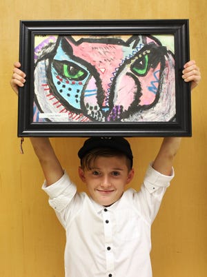 Colten Miller, a fifth-grader at Wadsworth Elementary School, holds his artwork that's on display at the emergency department. [Photos provided]