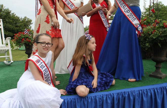 Miss and Little Miss Fourth of July runner ups, Sykler Silva, 9, left, and Claire Chace, 8, both of Bristol, sit on the float that they will be riding in the 230th Bristol Fourth of July Parade. [STEVE SZYDLOWSKI/THE PROVIDENCE JOURNAL]