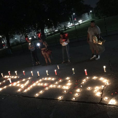 At South Worcester Playground on Camp Street on Wednesday, family and friends mourn 18-year-old Tafar Lewis, who was fatally shot Tuesday night on Gage Street. [T&G Staff/Steven H. Foskett Jr.]