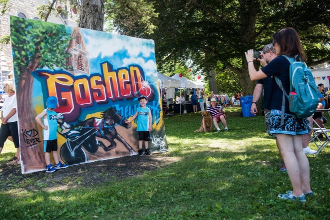Goshen proud - Martha Diaz of Goshen, right, takes a photos of Jonah Diaz 6, left, and Joshua Diaz, 5, in front of the Goshen, NY sign during the 2018 Great American Weekend.[TIMES HERALD-RECORD FILE PHOTO]