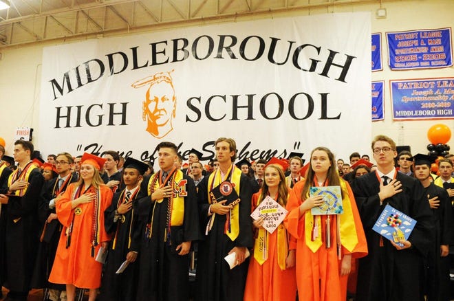 Middleboro High School’s Class of 2018 stands in front of the school’s logo, an image representing the Sachem mascot, at their commencement ceremony. [Enterprise file photo]