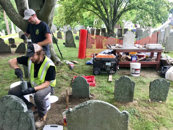 Colonial Stone workers complete repairs on a single phase of Burial Hill. Much more needs to be done. [Wicked Local Photo/Emily Clark]