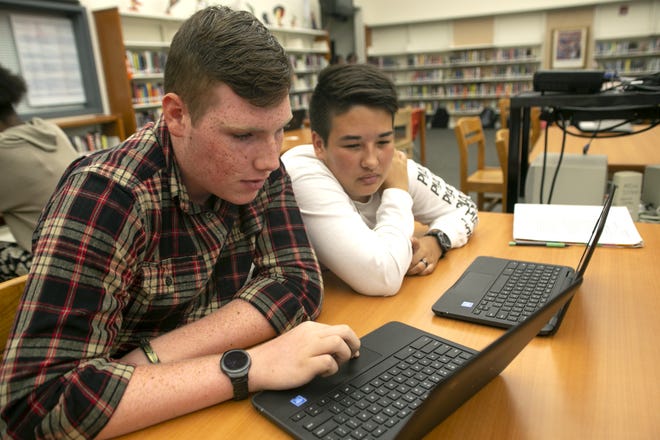Nick Dunaway and Brianna Williams work together on their new chrome books at Mount Dora High School in November 2018. [Daily Commercial file]