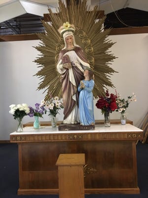 This statue of St. Anne in the lower St. Anne's shrine is a popular place to pray, visited by many faithful Catholics throughout the area. Tuesday, July 2, 2019. [Deborah Allard]